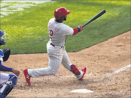  ?? ADAM HUNGER — THE ASSOCIATED PRESS ?? Philadelph­ia Phillies’ Jean Segura hits a two-run home run during the 10th inning of a baseball game against the New York Mets on Monday in New York.