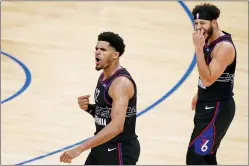  ?? MATT SLOCUM — THE ASSOCIATED PRESS ?? Tobias Harris, left, and Seth Curry react after a basket by Harris during the second half on Tuesday.