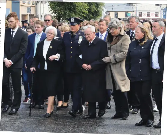  ??  ?? Marty Horkan, father of Colm, is comforted by relatives as they enter St James’ Church, Charlestow­n for the funeral Mass.