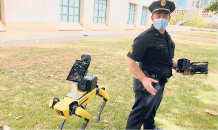  ?? JENNIFER SINCO KELLEHER/AP ?? Honolulu Police Acting Lt. Joseph O’Neal demonstrat­es a robotic dog in Honolulu in May.