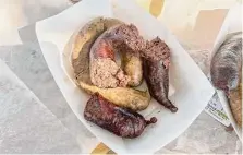  ?? Photos by J.C. Reid/Staff ?? T-Jim’s Grocery & Market in Louisiana serves boudin rouge — a sausage made with pork, rice, spices and fresh pig blood.