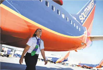  ?? Mason Trinca / Special to The Chronicle ?? Southwest Airlines 1st Officer Wendy Mora performs a general inspection at Oakland Internatio­nal Airport.