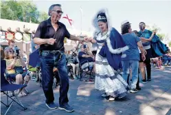  ?? PHOTOS BY JANE PHILLIPS/FOR THE NEW MEXICAN ?? ABOVE: Nestor Armijo, left, dances with the Fiesta’s La Reina, Christina Perea, at the closing ceremony Sunday on the Plaza.
BELOW: The dance group from Ohkay Owingeh Pueblo perform the Bow and Arrow Dance on Sunday during the Fiesta Mass.
BOTTOM: Crowds dance Sunday on the Plaza for the end of Fiesta.