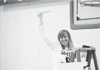  ?? ROB FOLDY ?? Lehigh women’s basketball coach Sue Troyan cuts down the nets after the Mountain Hawks won their fourth Patriot League title Sunday at Boston University.