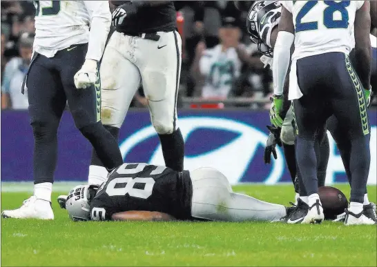  ?? Heidi Fang ?? Las Vegas Review-journal @Heidifang Raiders wide receiver Amari Cooper (89) lies on the field after getting hit by Seahawks strong safety Bradley Mcdougald during the second quarter Sunday at Wembley Stadium in London. Cooper appeared to lose consciousn­ess but later left the field under his own power.