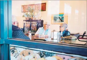  ?? Noah Berger For The Times ?? BOBBIE JO SEAVER, center, and June O’Sullivan, two of Jerry Brown’s cousins, chat at the Donut Wheel in Colusa, Calif. Seaver thinks the former governor is going to love the town. “He’s like a little boy in a sandbox.”