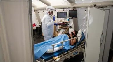  ?? Los Angeles Times/tns ?? Nurse Janil Wise, left, screens patient Sarah Bodle, who is pregnant and was exposed to a person with COVID-19, in the OB triage tent at Providence Holy Cross Medical Center in Mission Hills on July 10.