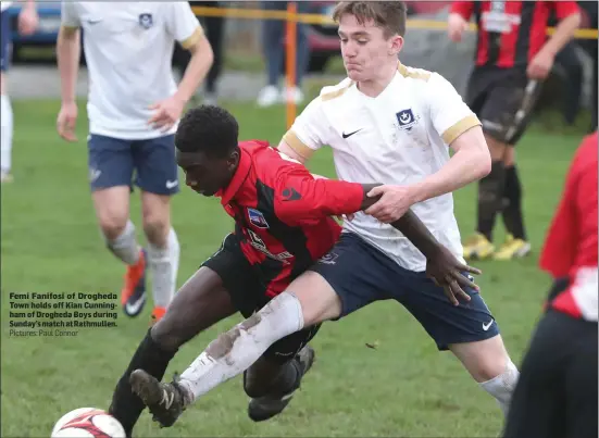  ??  ?? Femi Fanifosi of Drogheda Town holds off Kian Cunningham of Drogheda Boys during Sunday’s match at Rathmullen. Pictures: Paul Connor