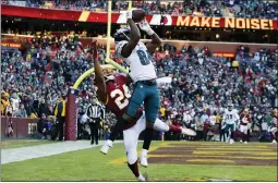  ?? ALEX BRANDON — THE ASSOCIATED PRESS ?? Philadelph­ia Eagles wide receiver Greg Ward (84) catches a touchdown pass beating out Washington Redskins cornerback Josh Norman (24) in the second half of an NFL football game, Sunday in Landover, Md. The Eagles won 37-27.