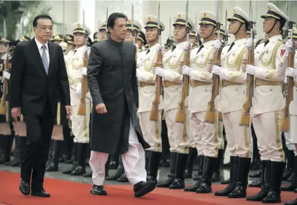  ?? Photo: AP ?? Chinese Premier Li Keqiang, left, and Pakistan’s Prime Minister Imran Khan review an honour guard during a welcome ceremony at the Great Hall of the People in Beijing on November 3, 2018.