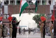  ??  ?? Border Security Force and Pakistan Rangers lower their countries’ flags during the Beating Retreat border ceremony on the occasion of 73rd Independen­ce Day, at Attari-wagah border post on 15 August.