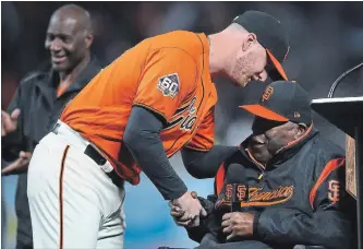  ?? ASSOCIATED PRESS FILE PHOTO ?? Giants pitcher Will Smith, left, shakes hands with Baseball Hall of Famer Willie McCovey after winning the 2018 Willie Mac award in September. McCovey, who played 19 seasons for the Giants, died Wednesday.