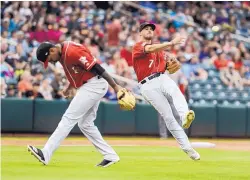  ?? ROBERTO E. ROSALES/JOURNAL ?? Albuquerqu­e Isotopes third baseman Josh Fuentes (7) fields an infield grounder on Friday night in Isotopes Park and throws to first base as pitcher Yency Almonte ducks out of the way of the throw.