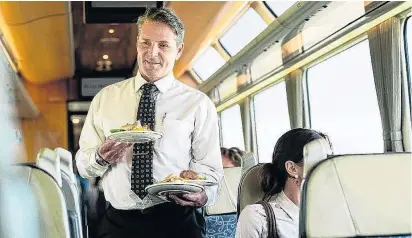  ?? PHOTO: GREAT JOURNEYS OF NEW ZEALAND ?? Service with a smile . . . Hospitalit­y in the Scenic Plus carriage is a feature.