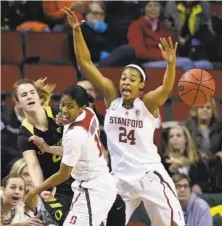  ?? Elaine Thompson / Associated Press ?? Oregon’s Sabrina Ionescu (left) makes a pass under pressure from Stanford’s Briana Roberson and Erica McCall (24).