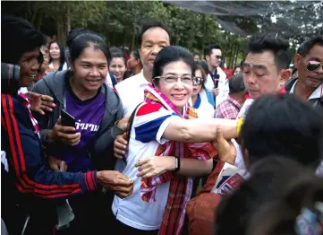  ?? — Reuters photo ?? Pheu Thai Party and Prime Minister candidate Sudarat (centre) greets her supporters during an election campaign in Ubon Ratchathan­i Province, Thailand.