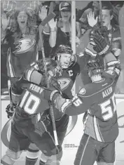  ?? Jae C. Hong ?? RYAN GETZLAF, center, celebrates a Game 2 goal against the Stars with Corey Perry and Bryan Allen.