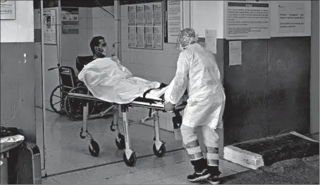  ?? SAMUEL ARANDA/THE NEW YORK TIMES ?? A suspected COVID-19 patient arrives Aug. 30 at a hospital in Malaga, Spain, a country where the virus is spreading even faster than in the United States.