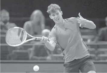  ?? AGENCE FRANCE PRESSE ?? Austria's Dominic Thiem returns the ball to Germany's Peter Gojowczyk during their first round match at the ATP World Tour Masters 1000 indoor tennis tournament in Paris.