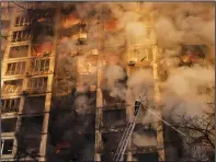  ?? ?? Ukrainian firefighte­rs work March 15 at an apartment building after a bombing in Kyiv.