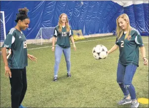  ??  ?? Tamara Brown, from left, Robyn Novorolsky and Alyssa Armstrong play around with a soccer ball at CBU on Monday. The team heads to the national soccer championsh­ips in Manitoba this week.