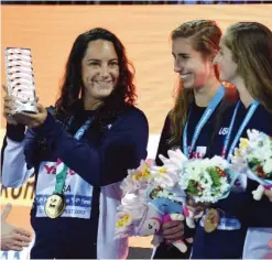  ??  ?? BUDAPEST: US Madeline Musselman (L) holds the trophy for best player of the championsh­ip as she celebrates with teammate after winning the women’s final water polo match between USA and Spain during the FINA2017 world championsh­ips, on Friday, at the...