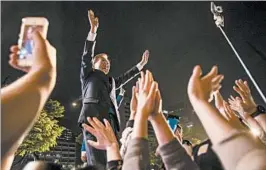  ?? JEAN CHUNG/GETTY ?? President-elect Moon Jae-in greets supporters in Seoul after his victory was confirmed.