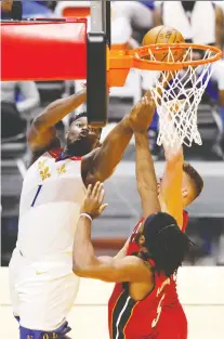  ?? MICHAEL REAVES/ GETTY IMAGES ?? Zion Williamson of the Pelicans goes up for two of his 32 points in a loss to the Heat on Friday in Miami, Fla.