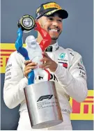  ??  ?? First home: Lewis Hamilton celebrates on the podium (left) after driving to victory in the French Grand Prix (right)