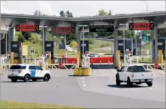  ?? AP PHOTO ELAINE THOMPSON ?? In this photo taken Sunday, a truck from Canada heads to the single open lane heading into the U.S. at the Peace Arch border crossing in Blaine, Wash. Canada and the U.S. have agreed to extend their agreement to keep the border closed to non-essential travel to June 21 during the coronaviru­s pandemic.