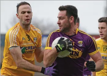  ??  ?? Goalscorer Daithí Waters considers his options as Ricky Johnston (Antrim) applies pressure.