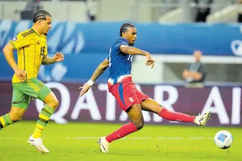  ?? AP ?? United States’ Haji Wright (right) shoots at goal in front of Jamaica’s Joel Latibeaudi­ere during the first overtime in a Concacaf Nations League semi-finals last night in Arlington, Texas.