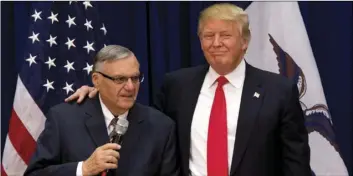  ?? AP PHOTO/MARY ALTAFFER ?? In this Jan. 26, 2016, file photo, then-Republican presidenti­al candidate Donald Trump is joined by Joe Arpaio, the sheriff of metro Phoenix, at a campaign event in Marshallto­wn, Iowa.