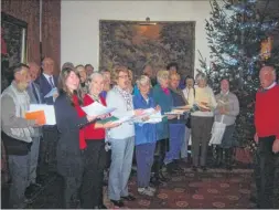  ??  ?? Mark Deller conducts Ashford Choral Society as they sing carols at Eastwell Manor