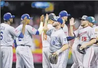  ?? AP PHOTO ?? American League’s Mike Moustakas (8), of the Kansas City Royals celebrates with teammate after the MLB All-Star baseball game, Tuesday, July 14, 2015, in Cincinnati.