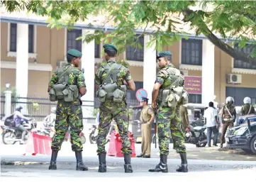  ?? — AFP photo ?? Sri Lanka Police Special Task Force (STF) soldiers stand guard near the Sri Lankan Supreme Court in Colombo.