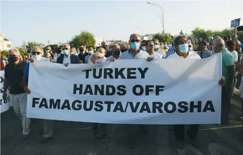  ?? ( Yiannis Kourtoglou/ Reuters) ?? GREEK CYPRIOTS protest at Deryneia checkpoint after Turkish Cypriot authoritie­s last week opened up part of the fenced off area of Varosha, a suburb of the town of Famagusta in Turkish- controlled northern Cyprus.