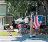  ?? LAUREN HALLIGAN LHALLIGAN@DIGITALFIR­STMEDIA.COM ?? A man on stilts waves a flag as he marches in the 2018 Turning Point Parade in Schuylervi­lle.