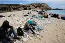  ?? Photograph: Vassilis Mathioudak­is/ EPA ?? People rest on Tripiti beach on Gavdos after disembarki­ng a fishing boat in April 2015.