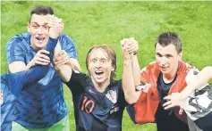  ??  ?? Croatia’s Luka Modric (centre) celebrates after winning the semi-final match against England at the Luzhniki Stadium in Moscow. — AFP photo