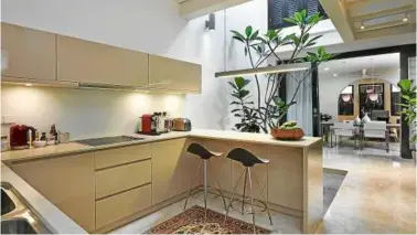  ??  ?? Kitchen by Paragon Kitchen features Caesarston­e counter tops, high-gloss finished cabinetry, STUA’s Onda bar stools and Teka appliances.