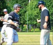  ?? KYLE MENNIG — ONEIDA DAILY DISPATCH ?? Sherrill’s Michael Wroth (21) is congratula­ted by coach Jimmy Hegmann after hitting his second home run against the Cortland Crush during Wednesday’s game.