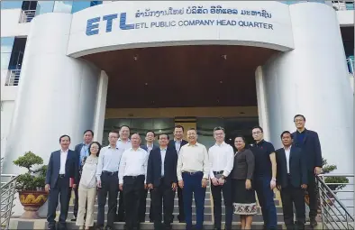  ?? PHOTOS PROVIDED TO CHINA DAILY ?? Empolyees of Comba Telecoms Systems Holdings Ltd take a photo with the management team in front of the building of the State-owned telecoms operator Enterprise of Telecommun­ications Lao.