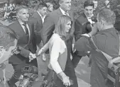  ?? PHILIP MARCELO/AP ?? In this Aug. 27, 2019, file photo, Lori Loughlin, center, departs federal court with her husband, clothing designer Mossimo Giannulli, left, in Boston.