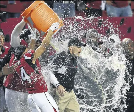  ?? STREETER LECKA / GETTY IMAGES ?? Jonathan Babineaux and Eric Weems dump Gatorade on Dan Quinn just before Sunday’s game ended. “That was a really cool experience,” Quinn said — “a moment I won’t forget.”