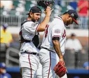  ?? TODD KIRKLAND / AP ?? Braves catcher David Freitas meets with rookie pitcher Luiz Gohara during the Rangers’ four-run fourth inning in Wednesday’s Game 1.