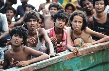  ??  ?? File photo taken on May 14, 2015 shows Rohingya migrants sitting in a boat drifting inThai waters off the southern island of Koh Lipe in the Andaman Sea. — AFP photo