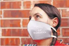  ??  ?? Norman Mayor Breea Clark wears a mask that promotes the city of Norman. [DOUG HOKE/ THE OKLAHOMAN]