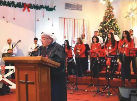  ??  ?? Above: Rev Amanuel Al Ghareeb leading the church service at National Evangelica­l Church in Kuwait City.