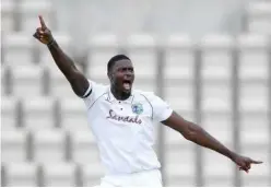  ?? Reuters ?? ↑
West Indies’ Jason Holder celebrates after taking the wicket of England’s Ben Stokes on the second day of their first Test match in Southampto­n on Thursday.